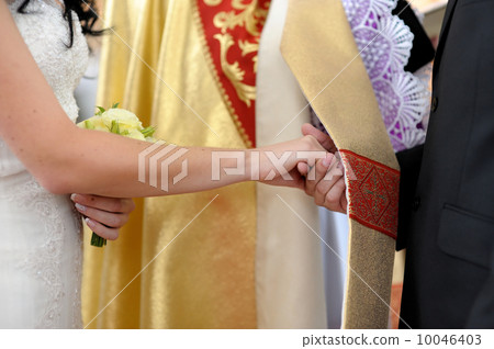 Bride and groom holding each other's hands Bride and groom holding each other's hands 10046403