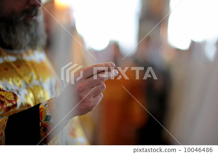 Orthodox priest holding wedding ring 10046486