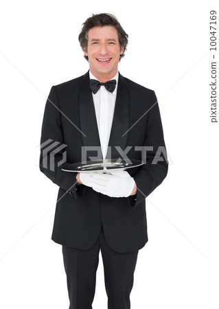 Happy waiter holding empty tray over white background Happy waiter holding empty tray over white background 10047169
