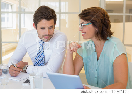 Business people looking at digital tablet in office Business people looking at digital tablet in office 10047301