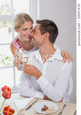 Happy couple with wine glasses having food 10047438