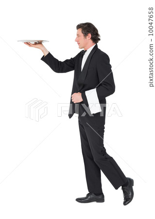 Waiter in suit carrying tray over white background Waiter in suit carrying tray over white background 10047658