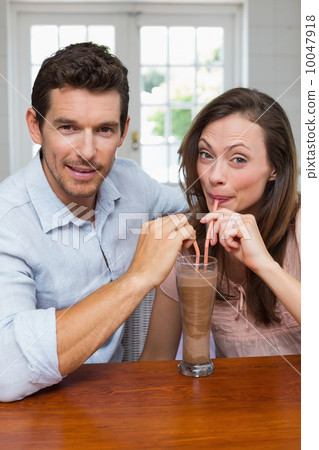 Loving young couple sharing a drink Loving young couple sharing a drink 10047918