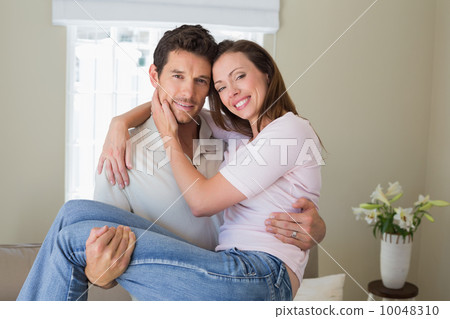 Smiling man carrying woman at home Smiling man carrying woman at home 10048310