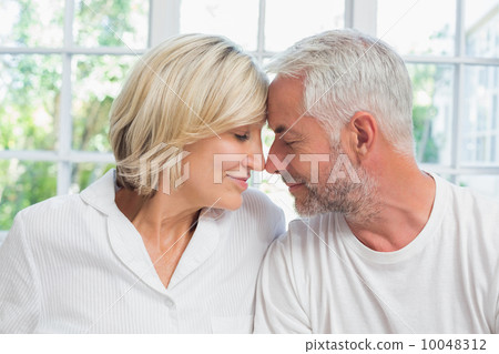Close-up of a relaxed mature couple with eyes closed at home Close-up of a relaxed mature couple with eyes closed at home 10048312