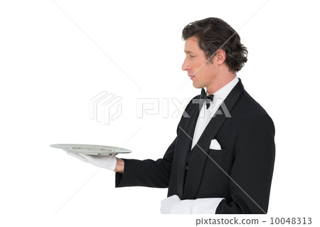 Handsome server holding tray over white background Handsome server holding tray over white background 10048313