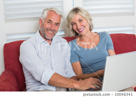 Portrait of a casual mature woman using laptop at home Portrait of a casual mature woman using laptop at home 10048341