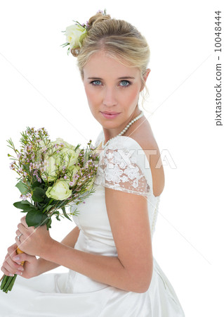 Bride holding rose bouquet over white background Bride holding rose bouquet over white background 10048444