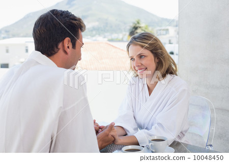 Loving couple holding hands at home Loving couple holding hands at home 10048450