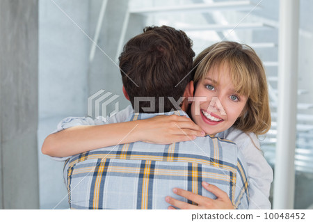 Loving young woman embracing man Loving young woman embracing man 10048452
