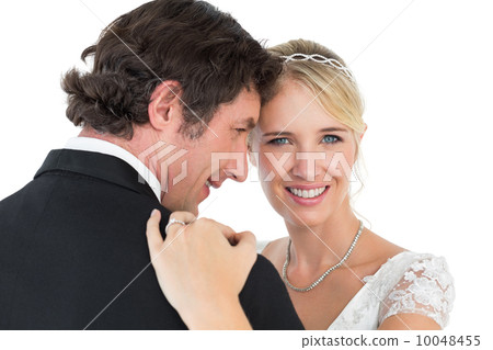 Bride embracing groom over white background 10048455