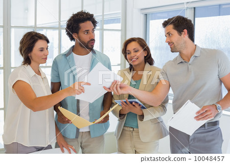 Business colleagues with documents in office Business colleagues with documents in office 10048457