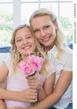 Mother and daughter with rose bouquet Mother and daughter with rose bouquet 10048458