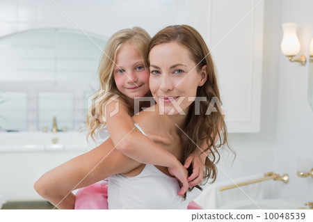 Woman carrying young girl in the house 10048539