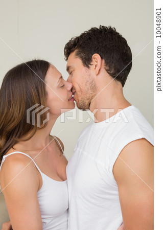 Side view of a loving couple kissing Side view of a loving couple kissing 10048901