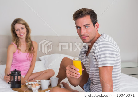 Happy couple having breakfast in bed Happy couple having breakfast in bed 10049071