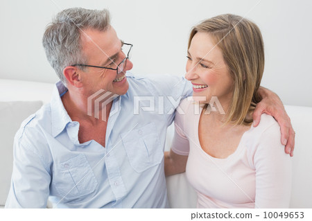 Happy relaxed couple sitting on sofa Happy relaxed couple sitting on sofa 10049653