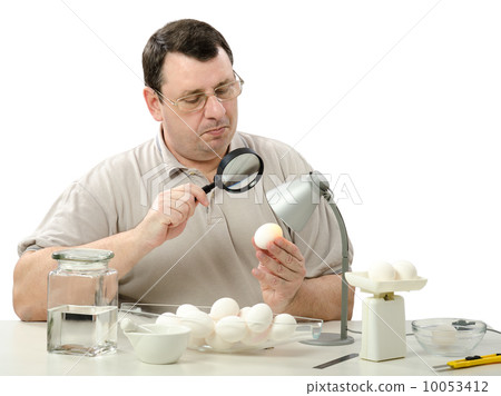 Phytocontrol engineer stares at white chicken eggs Phytocontrol engineer stares at white chicken eggs 10053412