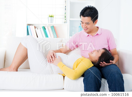 Asian pregnant couple having conversation Asian pregnant couple having conversation 10061516