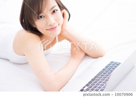 A woman using a personal computer in a room 10070906