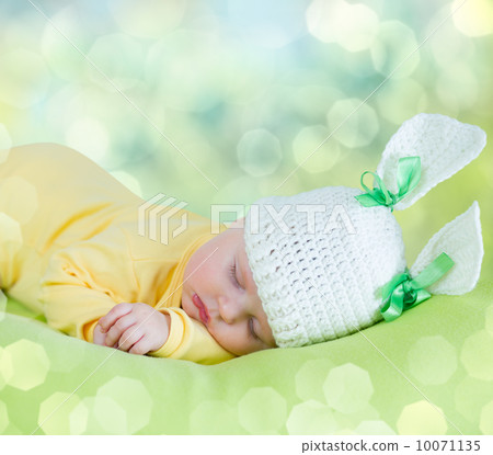 sleeping baby closeup portrait in hare or rabbit hat 10071135