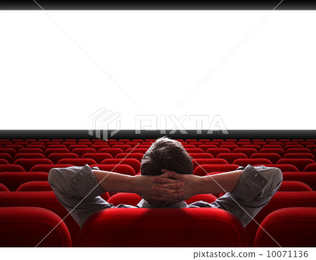 man sitting alone in empty cinema hall 10071136