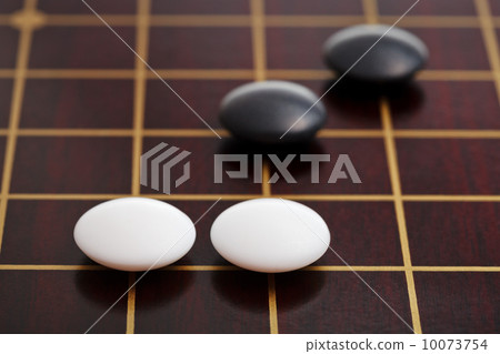 few stones during go game playing on goban 10073754
