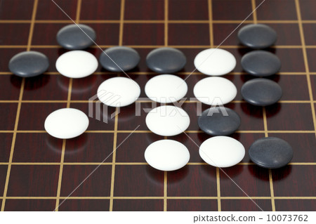 many stones during go game playing on goban 10073762
