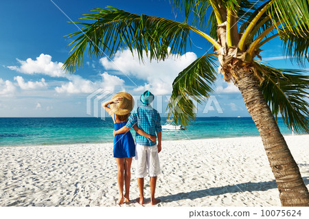 Couple in blue clothes on a beach at Maldives 10075624