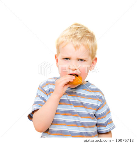 Cute little boy eating delicious cookie isolated on white Cute little boy eating delicious cookie isolated on white 10076718