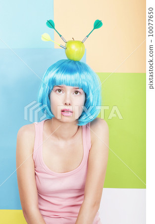 Stylized Woman with Apple on her Blue Haired Head. Series of Photos 10077650