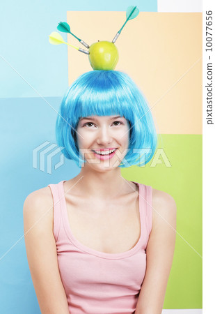 Precision. Amusing Woman in Blue Wig, Green Apple and Darts 10077656
