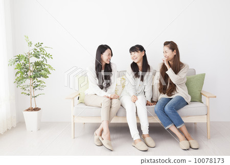 3 women relaxing on the sofa 10078173