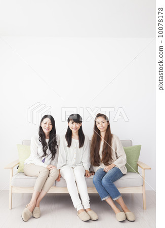 3 women relaxing on the sofa 10078178