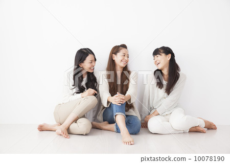 Three women sitting on the floor 10078190