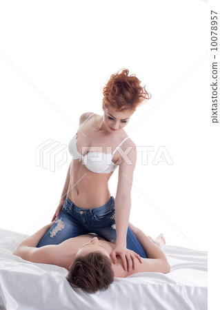 Red-haired girl sitting astride on her boyfriend 10078957
