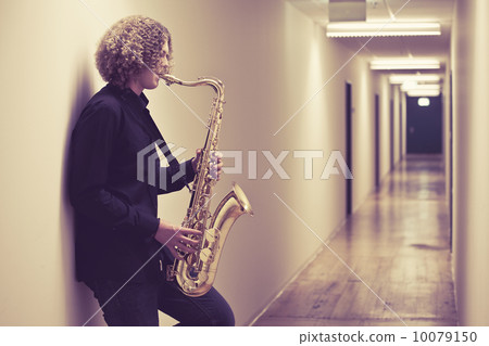 Man playing the saxophone in a hallway Man playing the saxophone in a hallway 10079150
