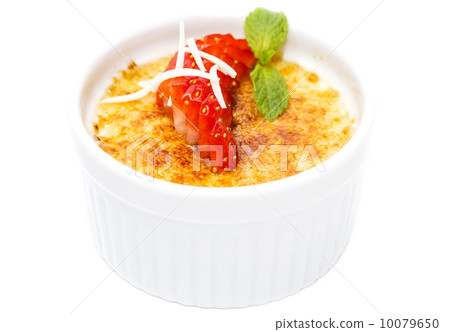creme brulee garnished with strawberries on a white background creme brulee garnished with strawberries on a white background 10079650