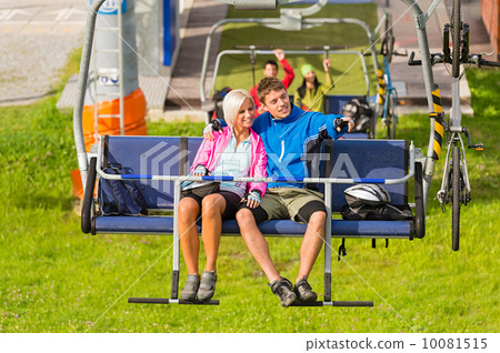 Couple on chair lift enjoying landscape 10081515