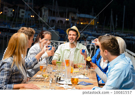 Young people doing shots at outside bar Young people doing shots at outside bar 10081557