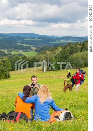 Hiking friends taking picture in scenic landscape Hiking friends taking picture in scenic landscape 10081563