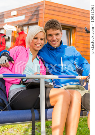 Smiling young couple sitting together char lift Smiling young couple sitting together char lift 10081565