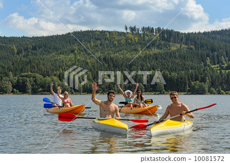 Waving cheerful friends in kayaks summer 10081572