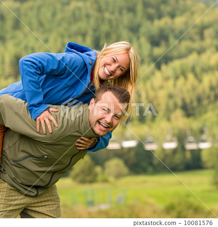 Couple having piggyback ride outside green nature Couple having piggyback ride outside green nature 10081576
