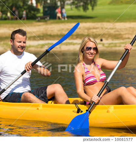 Couple sitting in kayak on a sunny day Couple sitting in kayak on a sunny day 10081577