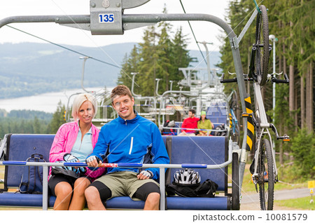 Chair lift going through forest couple sitting 10081579