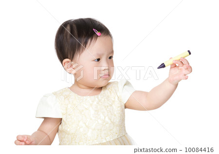 Asia baby girl looking at crayon 10084416