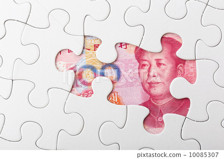 Incomplete puzzle over chinese yuan banknote background Incomplete puzzle over chinese yuan banknote background 10085307