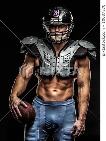 American football player with ball wearing helmet and protective shields 10087870