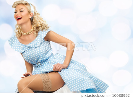 Sexy coquette blond pin up style young woman in blue dress 10088992